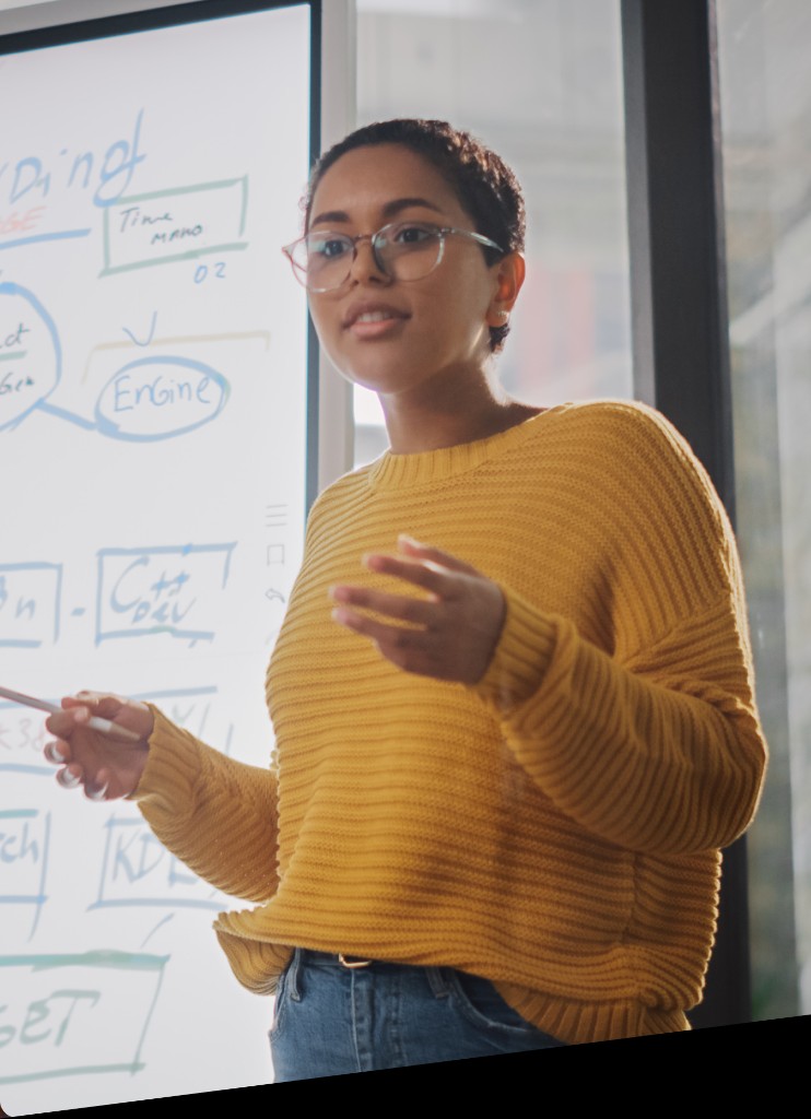 Woman presenting market analysis at whiteboard